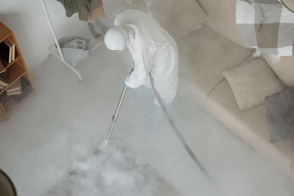 Biohazard cleanup technician in protective equipment, Crow Agency, MT